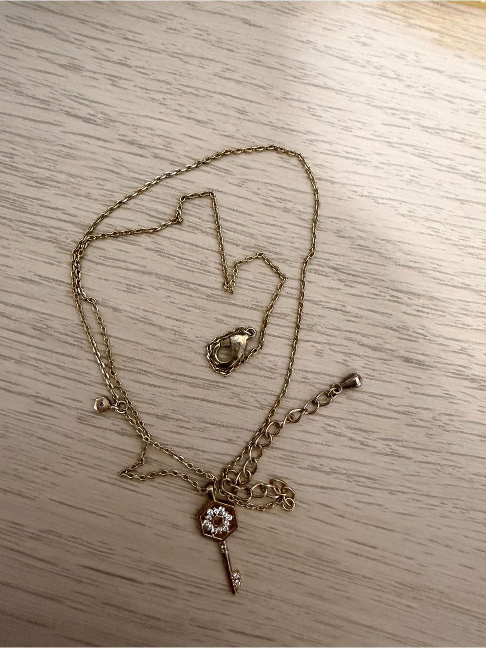 Gold Key Pendant Necklace with Sparkling Accent